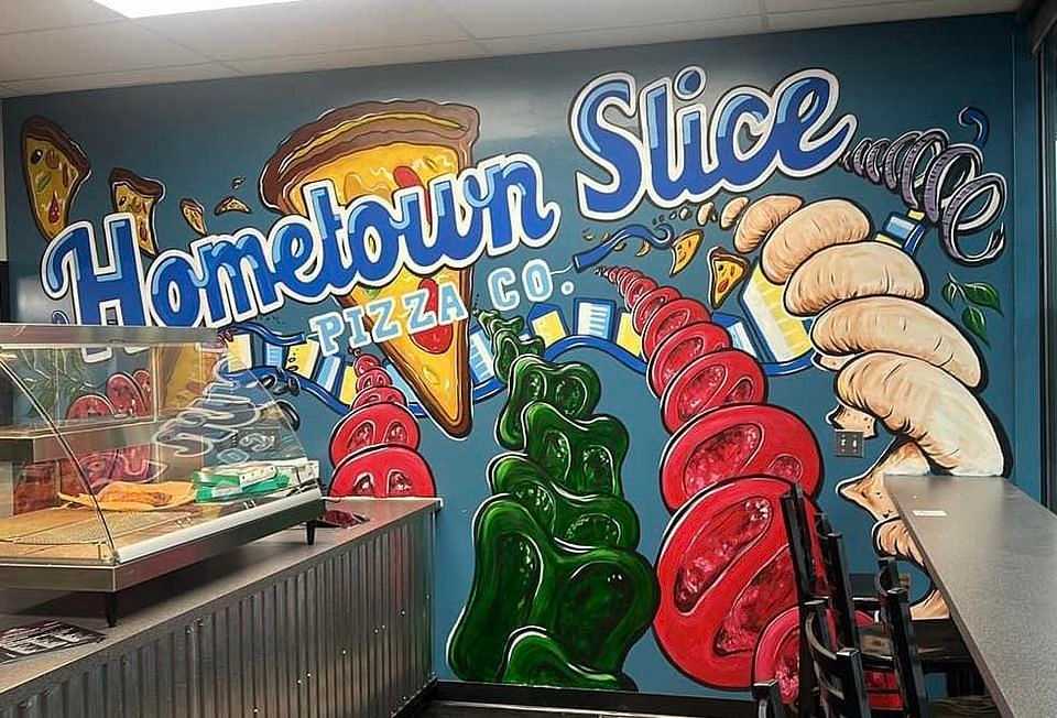 Colorful Hometown Slice Pizza Co. mural with pizza, pepperoni, soda, and a cozy dine-in counter.