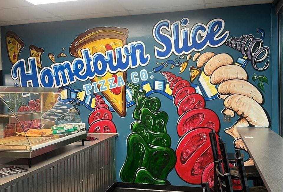 Colorful Hometown Slice Pizza Co. mural with pizza, pepperoni, soda, and a cozy dine-in counter.